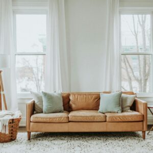 A cozy minimalist living room with a leather sofa and stylish decor.